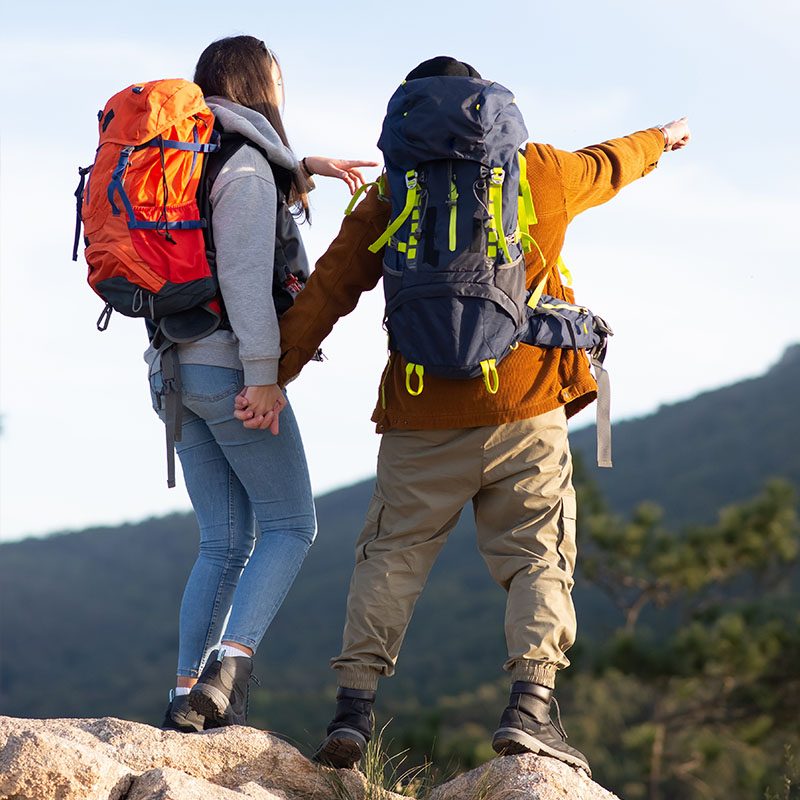 A couple going on a hike pointing at the view